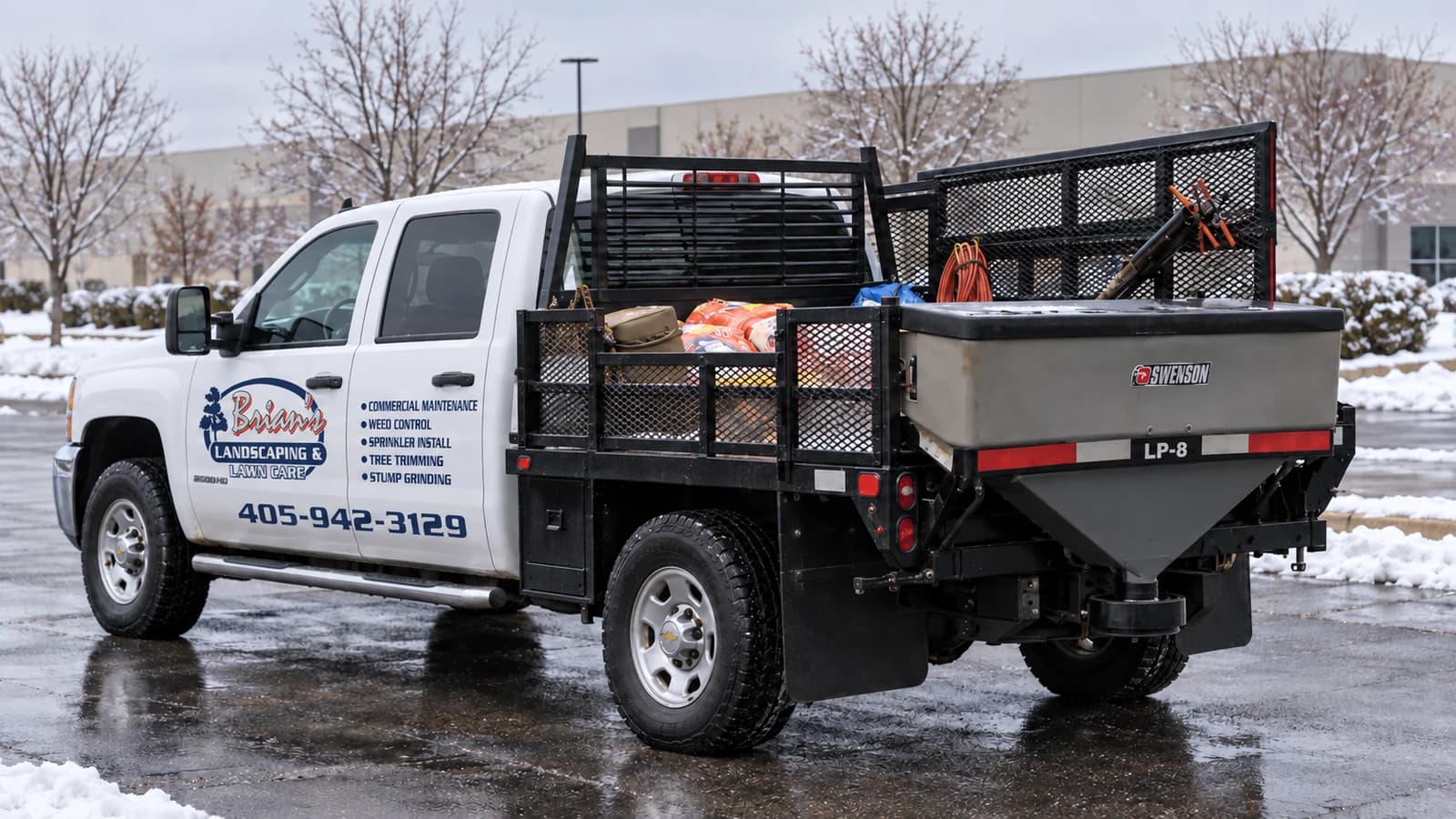 White Brian’s Landscaping & Lawn Care utility truck with a rear salt spreader in a winter setting